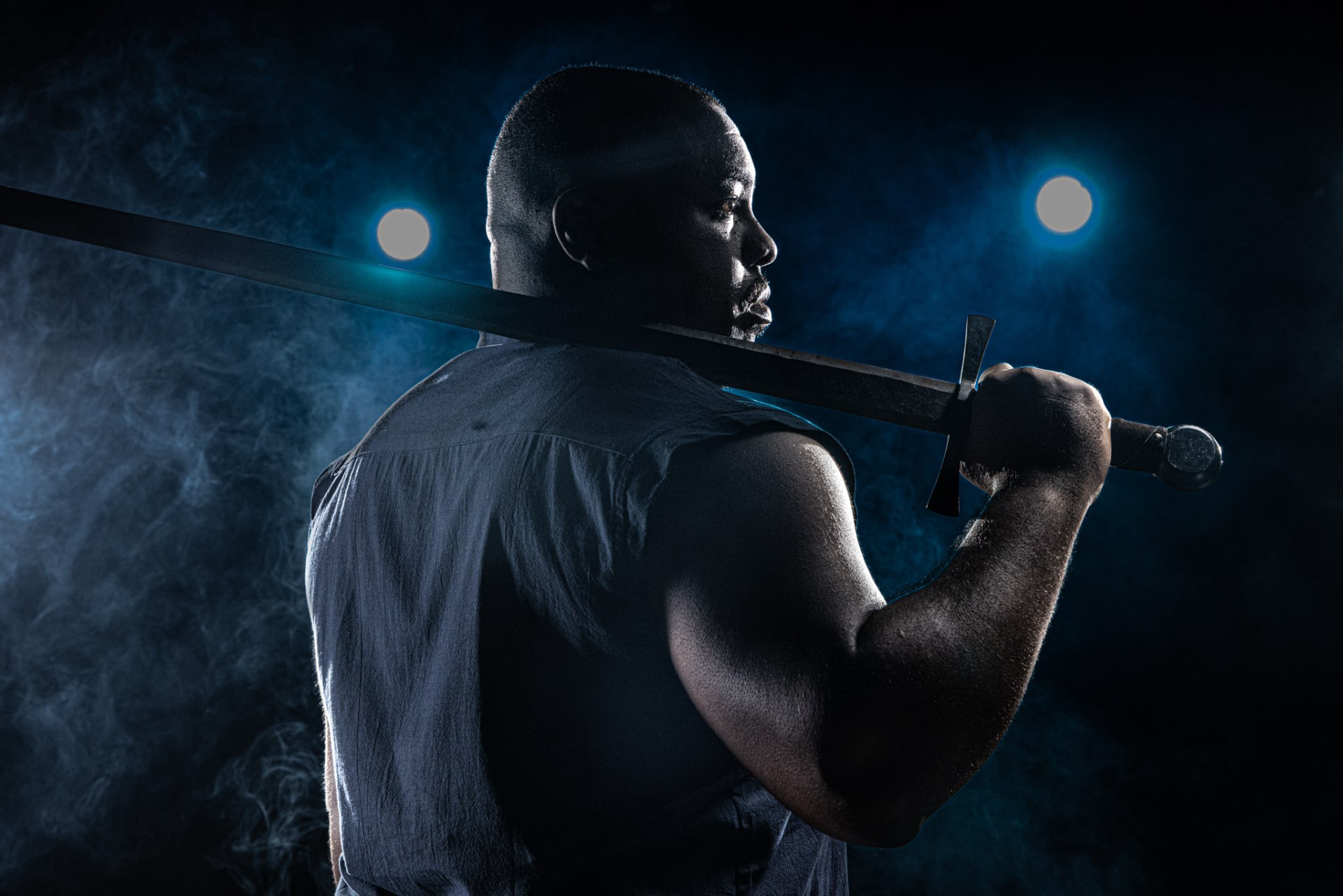 Warrior with sword in blue smoke