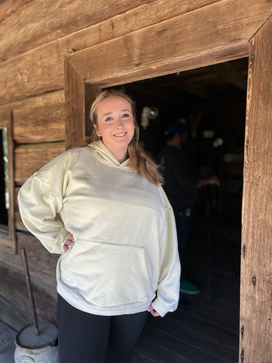 A cast member posing in the doorway of the log cabin